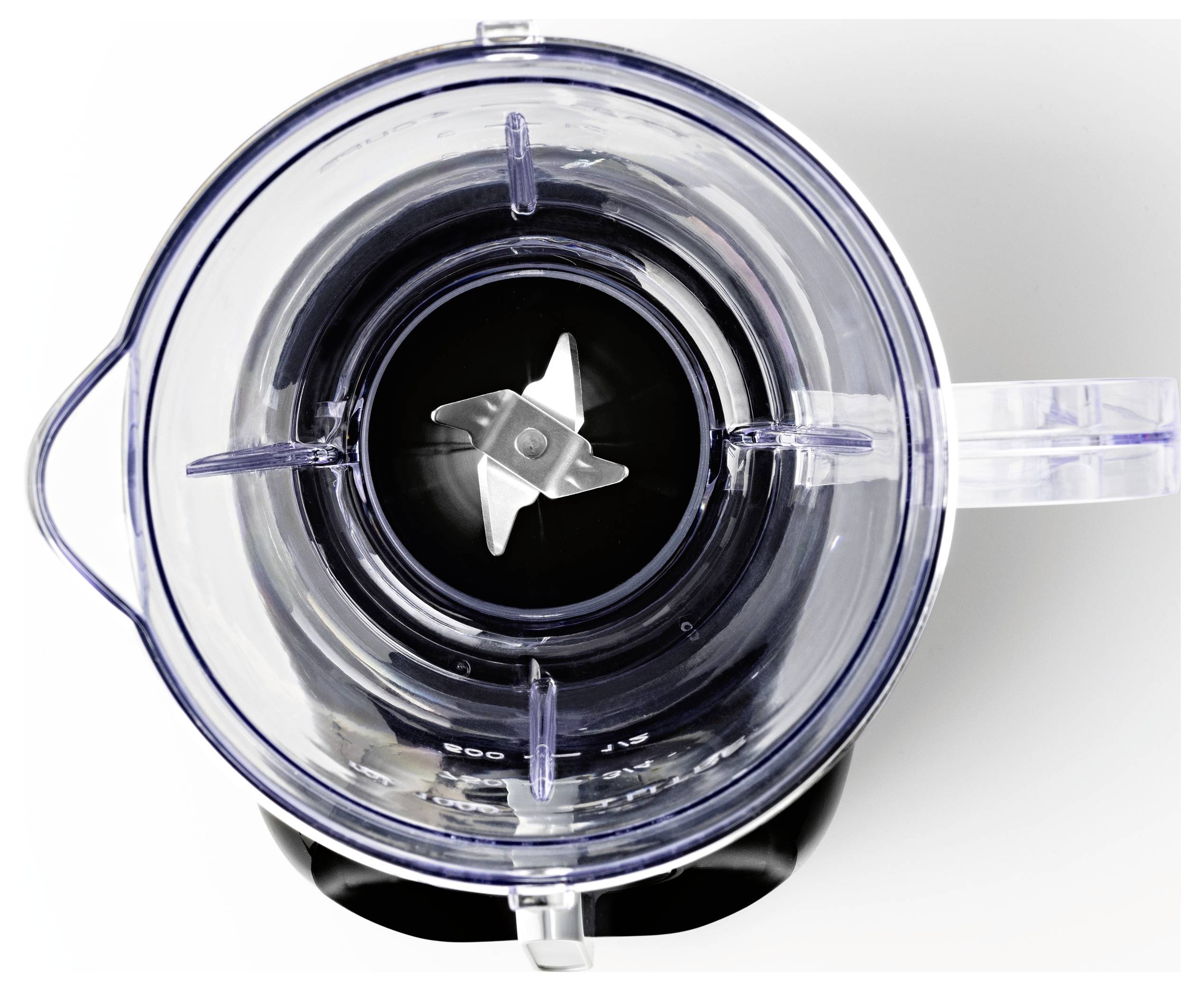 Un bol mélangeur vide vu de dessus, avec les lames en acier inoxydable visibles au centre.