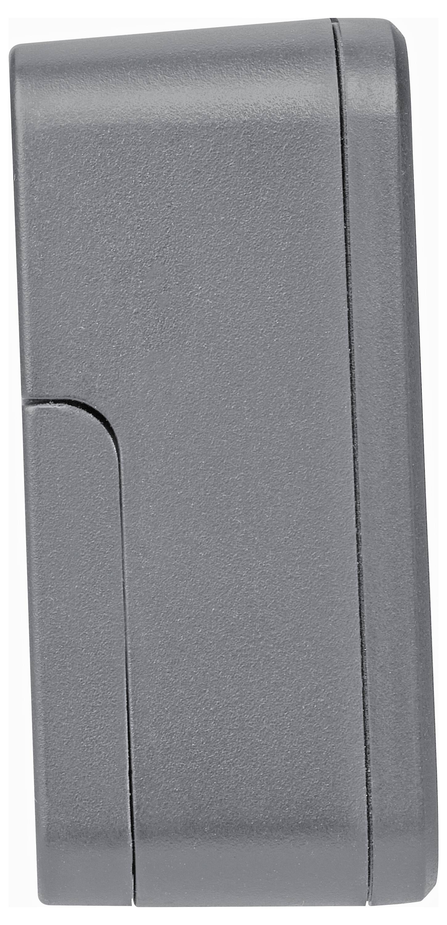 Objet rectangulaire gris avec un boîtier lisse et fermé, présentant des angles arrondis.