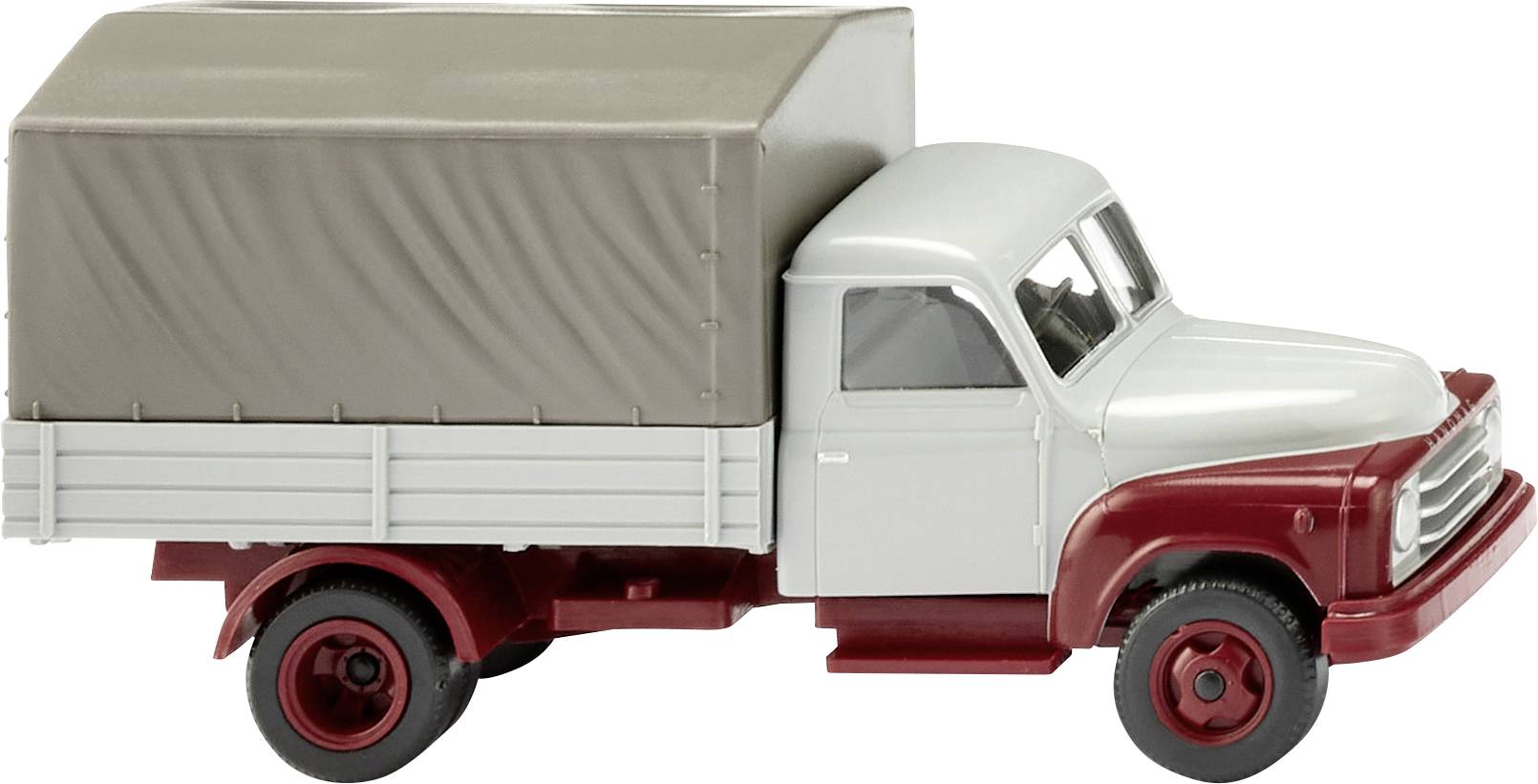 Un camion-jouet gris et rouge avec une bâche. Le camion est en plastique et est présenté de côté.