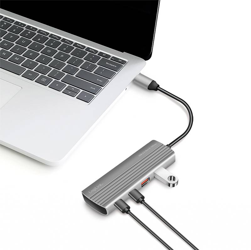 Ordinateur portable avec un hub USB connecté, offrant plusieurs ports, dont USB-C, USB-A et HDMI. Une clé USB est branchée.