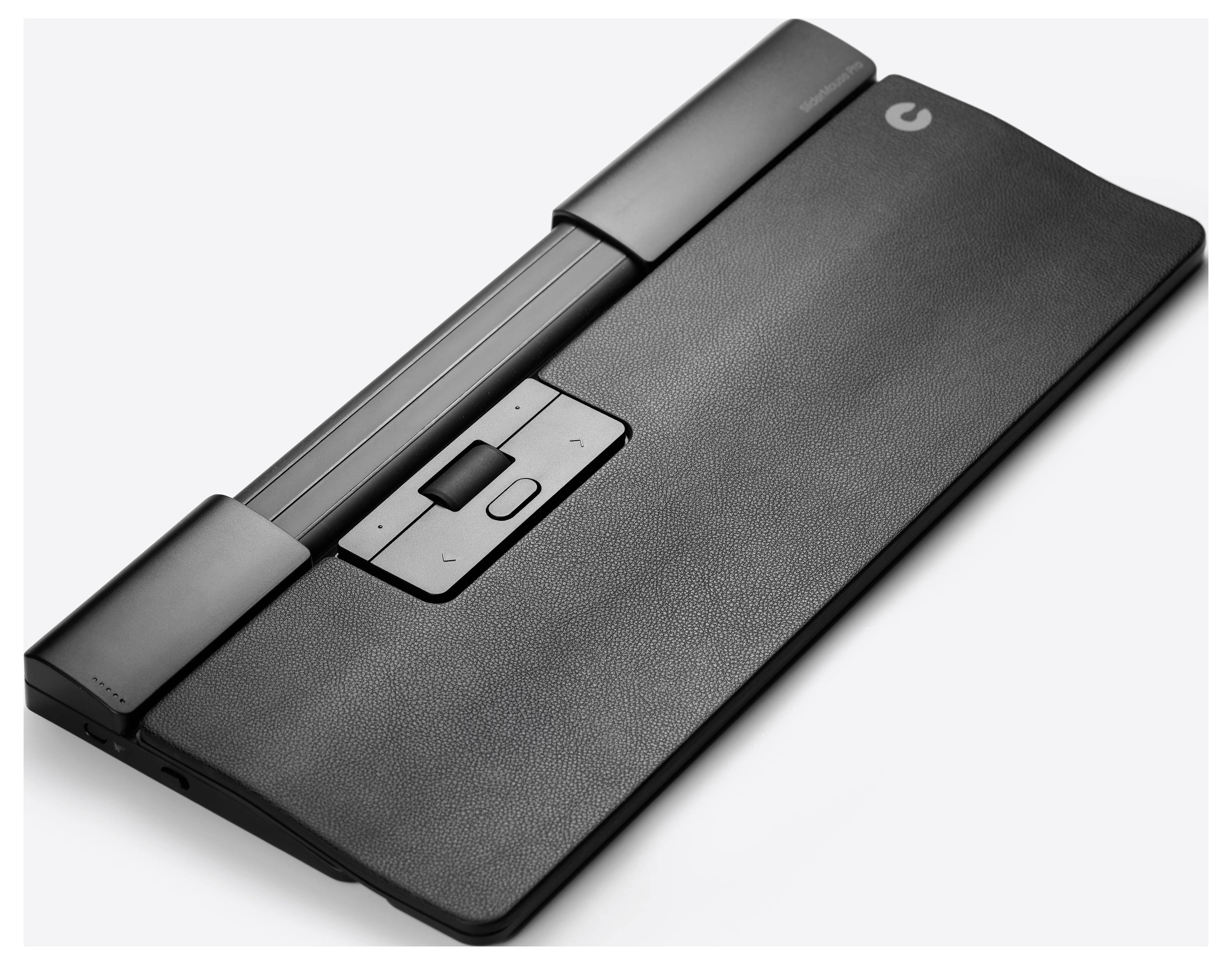 Un appareil électronique avec un boîtier noir et une surface de contrôle centrale, possiblement un accessoire portable de saisie ou un périphérique d'entrée.