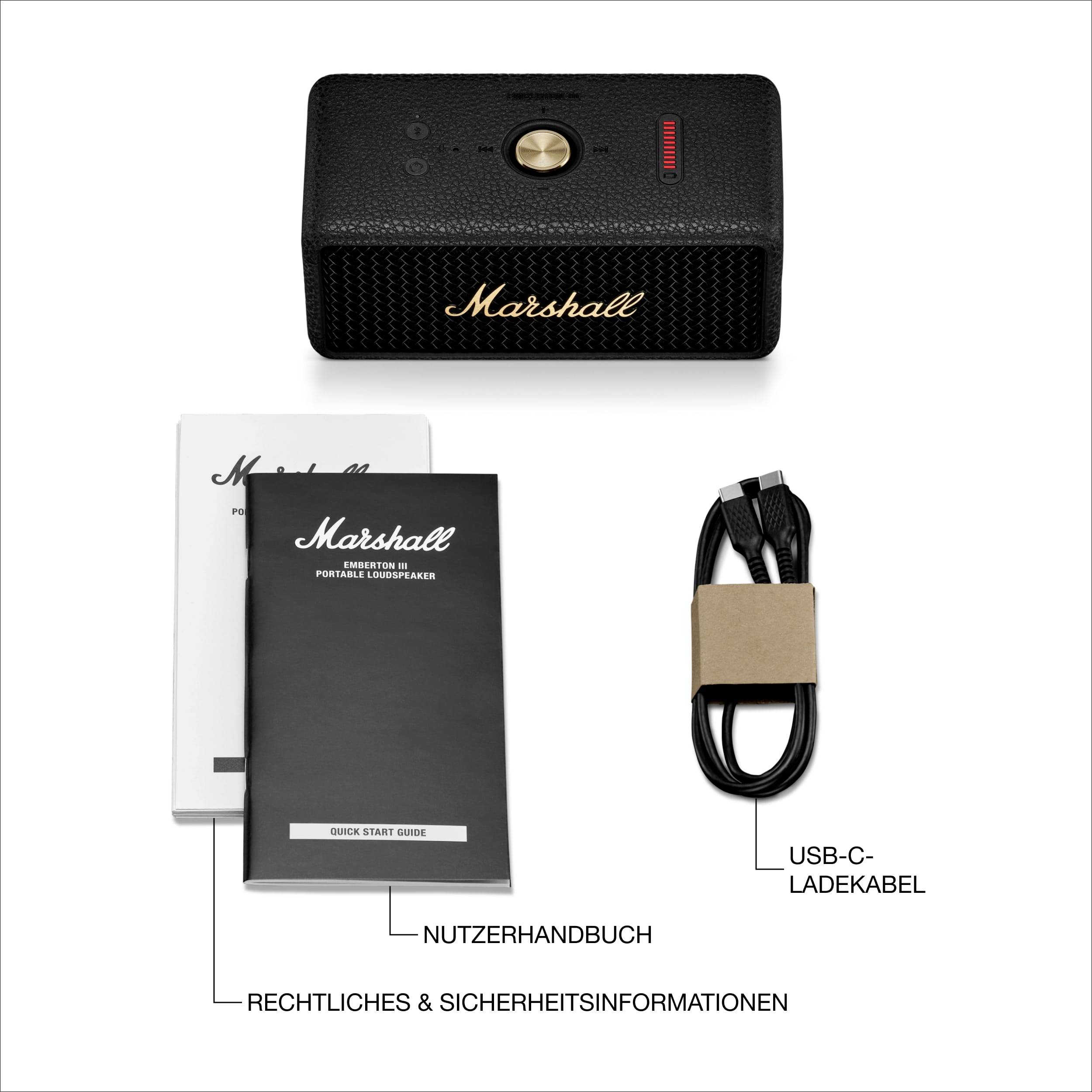 Enceinte portable Marshall noire avec bouton doré, câble de charge USB-C fourni, manuel d'utilisation et informations de sécurité.