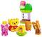 Kit de construction Lego avec des briques colorées montrant une figurine mangeant du miel, entourée de figurines d'animaux joyeux et d'une petite maison.