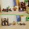 Deux ensembles de construction LEGO Minecraft sur une table. En haut à gauche, quelques figurines de personnages et des bâtiments représentant une scène de Minecraft.