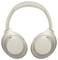 Casque sans fil over-ear de couleur beige clair, avec des écouteurs rembourrés et un arceau. Le nom de la marque 'Sony' est représenté sur les deux côtés.