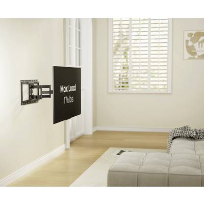 Support de téléviseur à écran plat fixé au mur, montrant un écran avec l'inscription "Max Load 176 lbs", dans un salon lumineux avec un canapé.