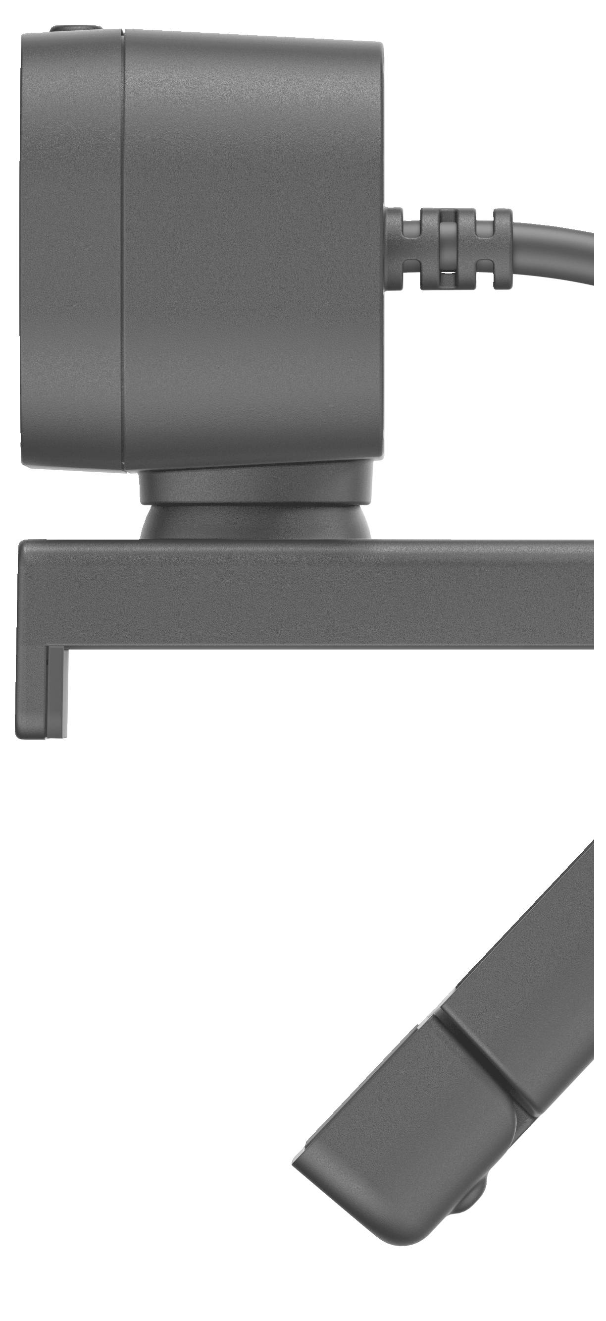 Une webcam grise, rectangulaire avec un câble, est montée sur un écran. La caméra est orientée sur le côté.