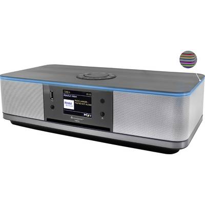 Système audio élégant avec écran, façade de haut-parleurs et port USB. L'écran affiche une station de radio avec le titre en cours de lecture.