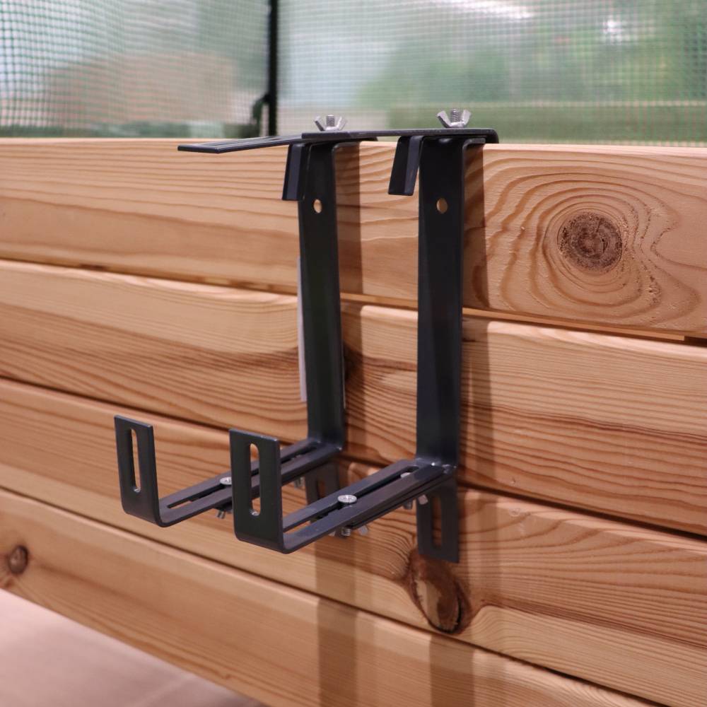 Supports métalliques fixés à un mur en bois, prêts à installer des étagères ou des appareils.