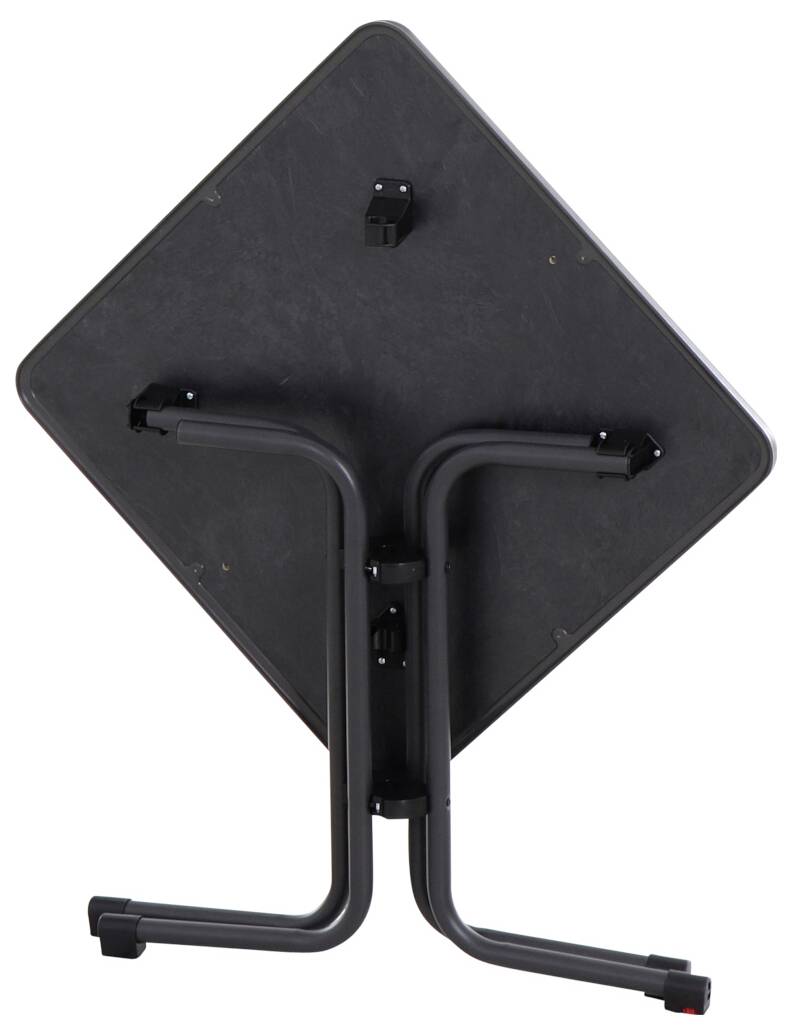 Une table noire retournée avec des pieds repliés, appuyée verticalement.