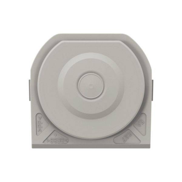 Dispositif gris, rond, avec des rainures creusées et un point central, probablement un composant technique ou un capuchon de connexion.