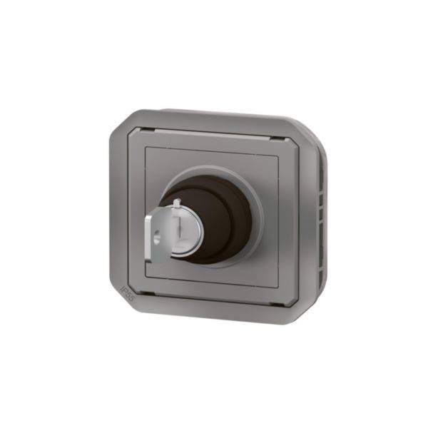 Un interrupteur rotatif gris électrique dans un boîtier carré, utilisé pour mettre en marche et arrêter des appareils.