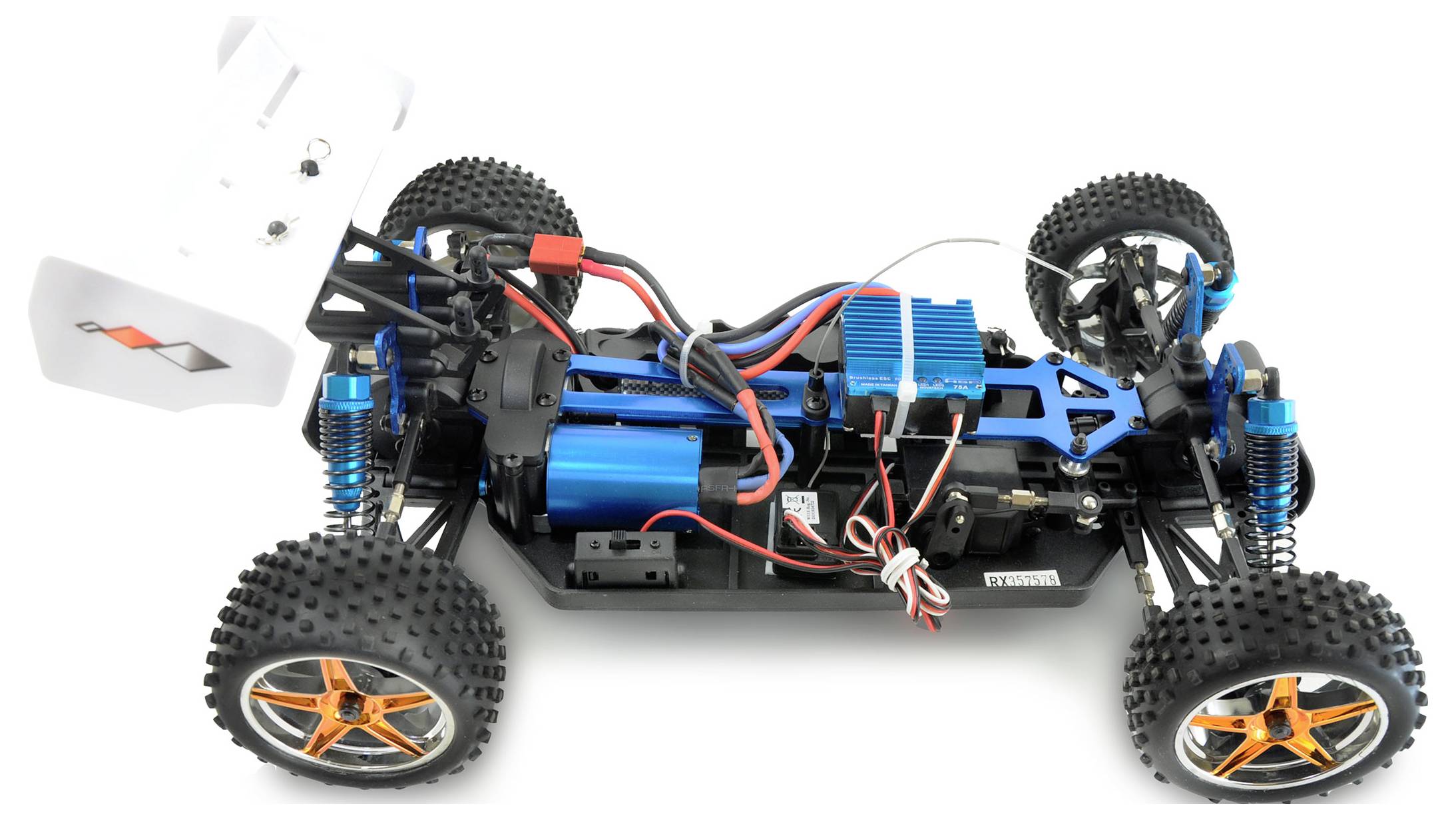 Voiture télécommandée sans carrosserie, montrant l'électronique bleue et les câbles rouge et noir sur un châssis noir avec des roues oranges.