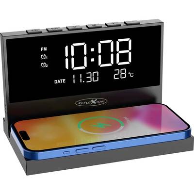 Réveil numérique avec affichage de la température. Il indique '10:08', la date '11.30' et la température '28°C'. Un smartphone est en train de charger sans fil.