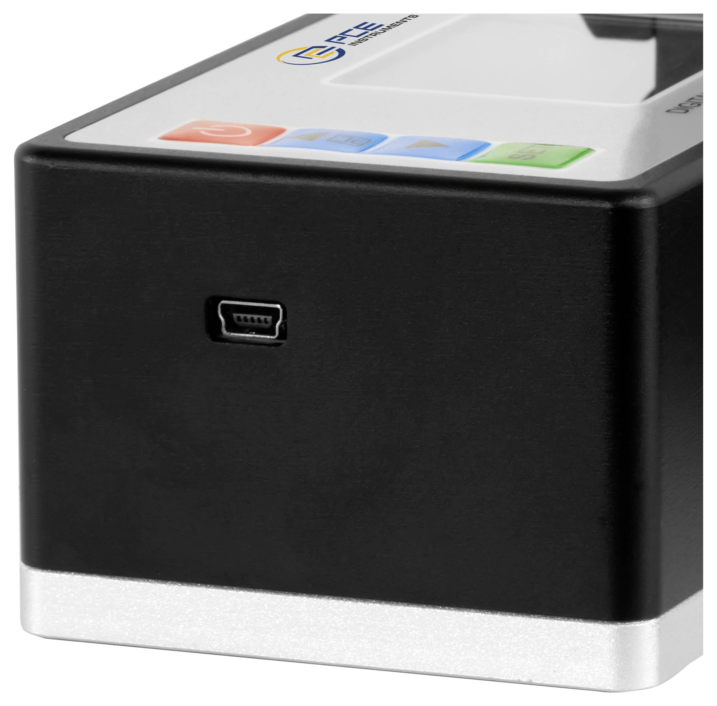 Gros plan d'un petit appareil électronique noir et argenté avec un port micro-USB frontal et des boutons tactiles colorés sur le dessus.