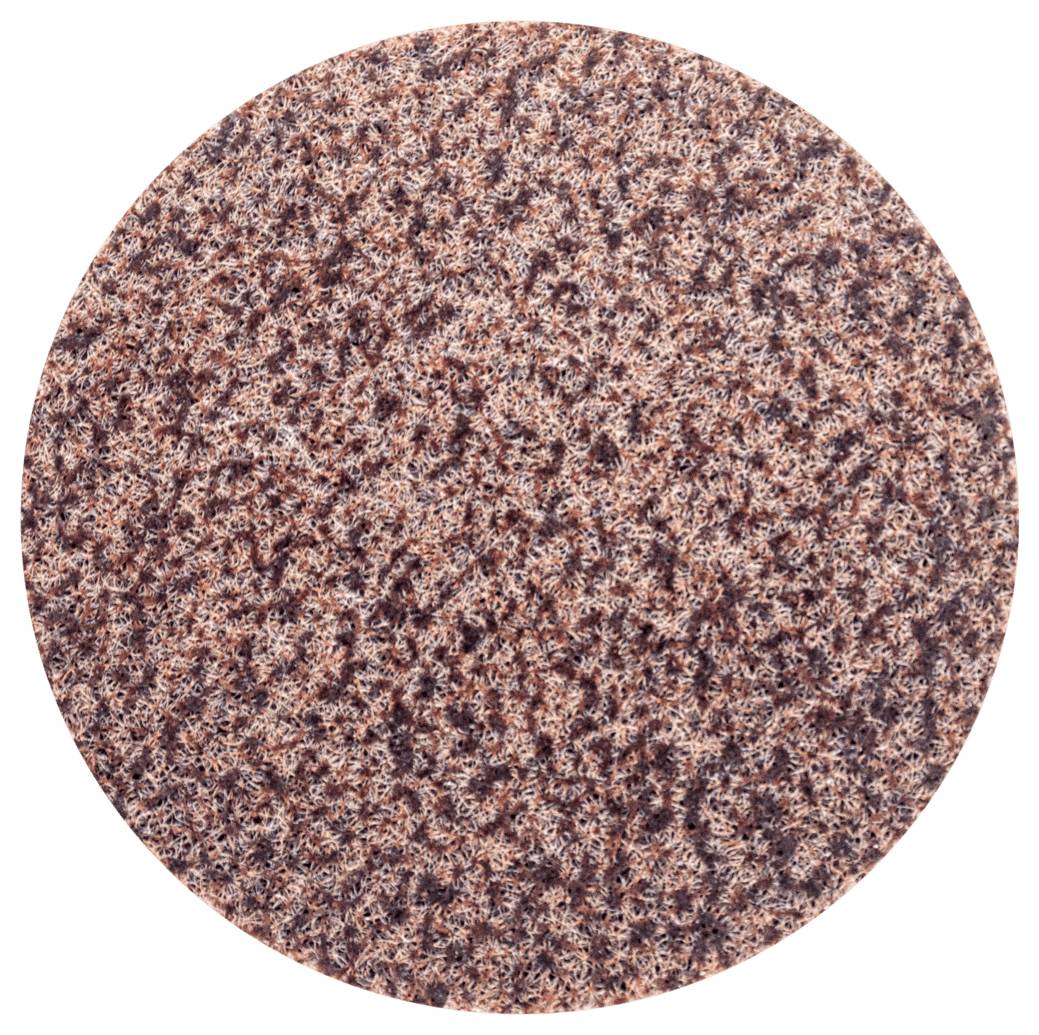 Gros plan circulaire d'une surface granulée brun foncé, probablement du papier de verre ou un matériau similaire.