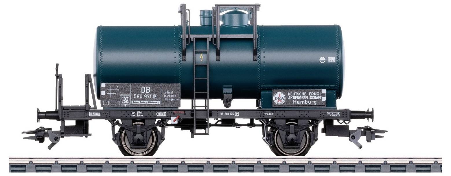 Sur l'image, on peut voir un wagon de marchandises vert utilisé par la Deutsche Bahn, circulant sur une voie ferrée. Le wagon a une forme cylindrique.