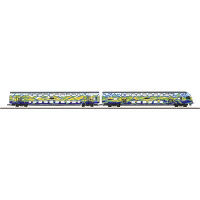 Un train coloré avec des wagons décorés de graffitis. Le train est stationné sur une voie ferrée.
