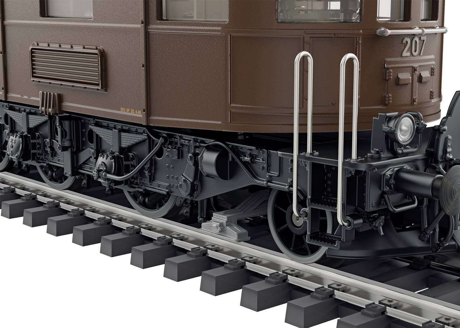 Gros plan d'un wagon de train brun sur des rails, montrant des pièces mécaniques détaillées et des câbles en dessous.