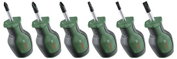 Six tournevis verts et noirs avec différents embouts, disposés en ligne.