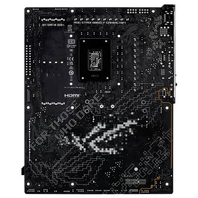 Une carte mère d'ordinateur noire vue de dos, montrant divers circuits, connexions et la zone de montage du processeur central.