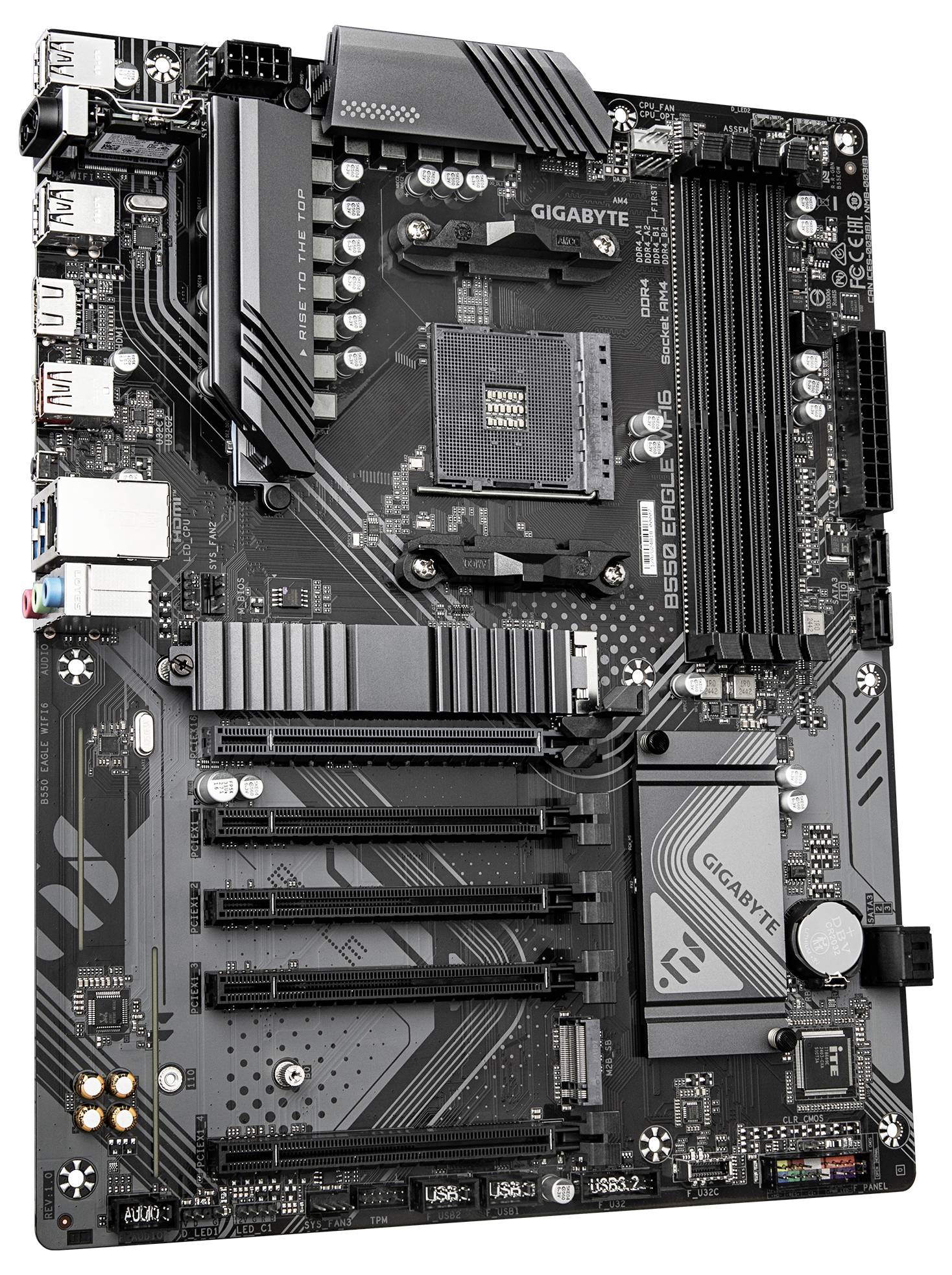 Un gros plan d'une carte mère Gigabyte B550 Aorus Elite V2 montrant les emplacements PCI, les slots RAM, et divers connecteurs et composants.