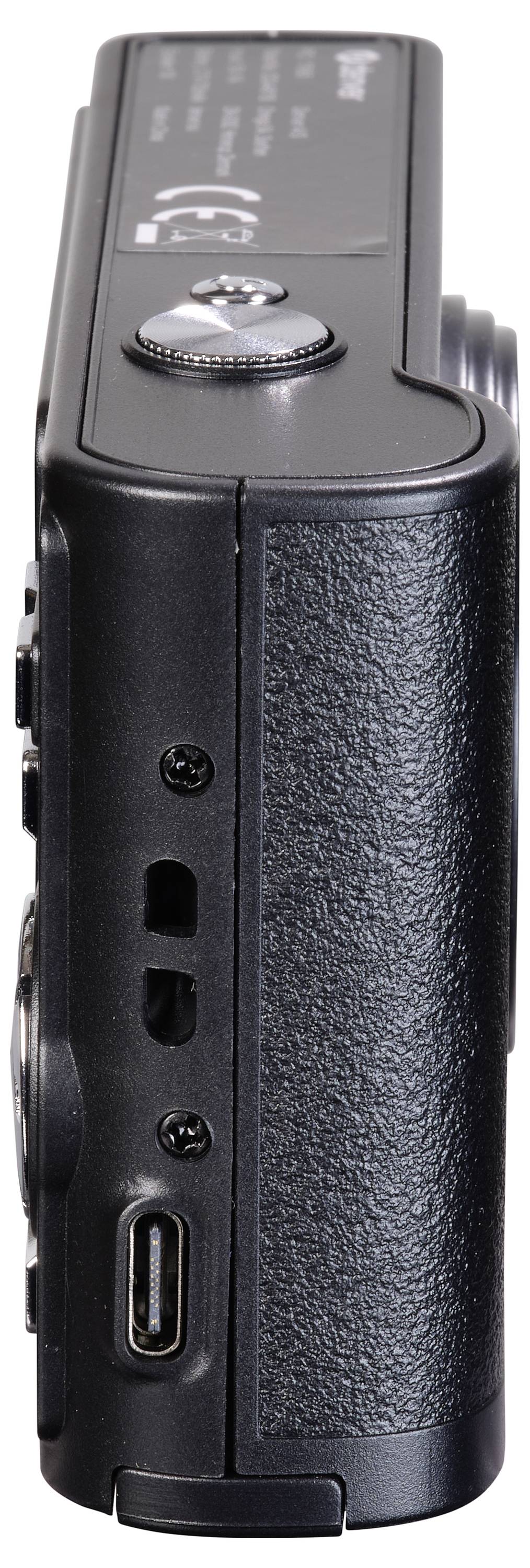 L'image montre la vue latérale d'un appareil photo numérique compact noir avec plusieurs ports et commandes.