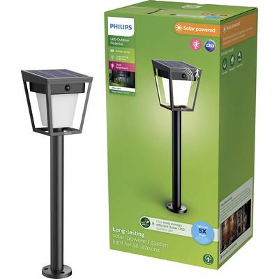 Lampe de jardin solaire Philips avec base noire, éclairage LED et panneau solaire, présentée à côté de son emballage.