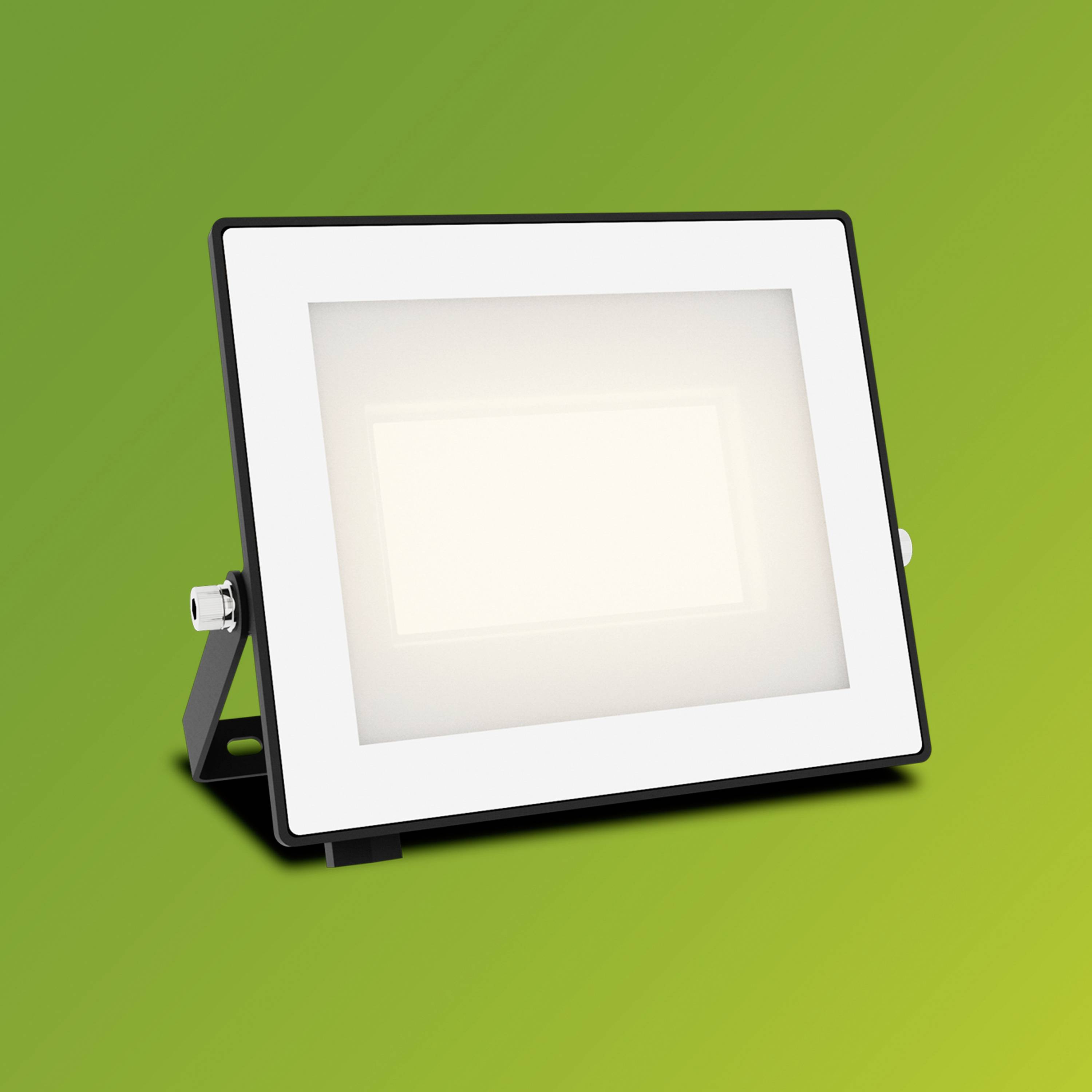 Projecteur LED rectangulaire avec cadre blanc et verre dépoli sur un fond vert. Idéal pour l'éclairage extérieur.