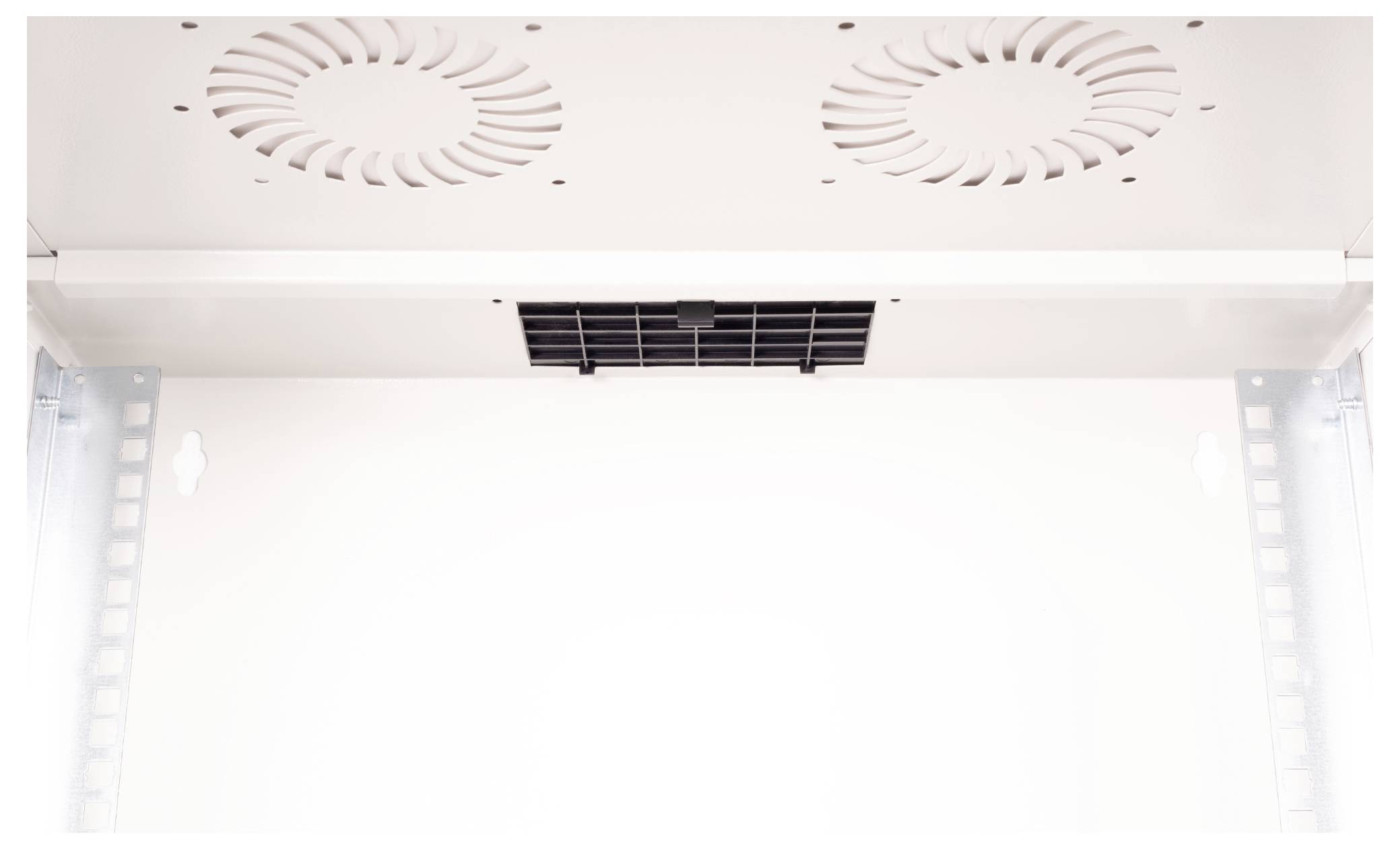 Vue rapprochée des grilles de ventilation d'un ventilateur de refroidissement à l'intérieur d'un boîtier ou d'un coffret de couleur claire, indiquant la configuration du système de ventilation.