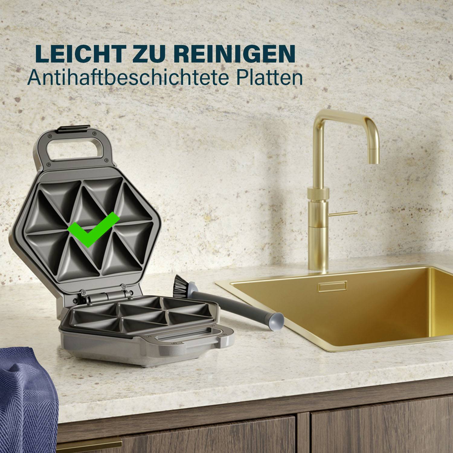 Facile à nettoyer et Plaques anti-adhésives avec un crochet vert, à côté d'un évier sur le plan de travail.