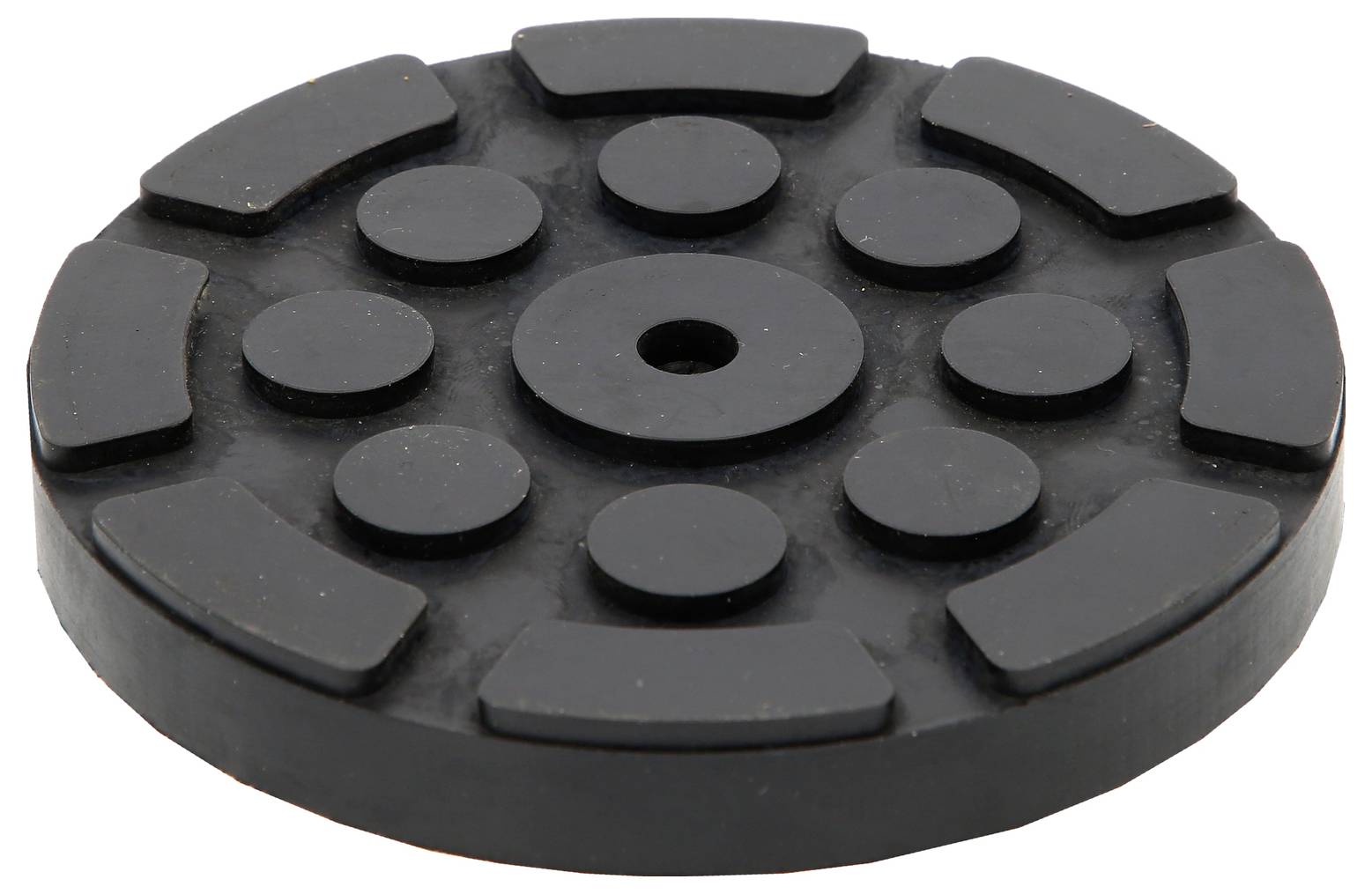 'Coussin noir et rond en caoutchouc avec des reliefs rectangulaires et circulaires disposés de manière circulaire.'