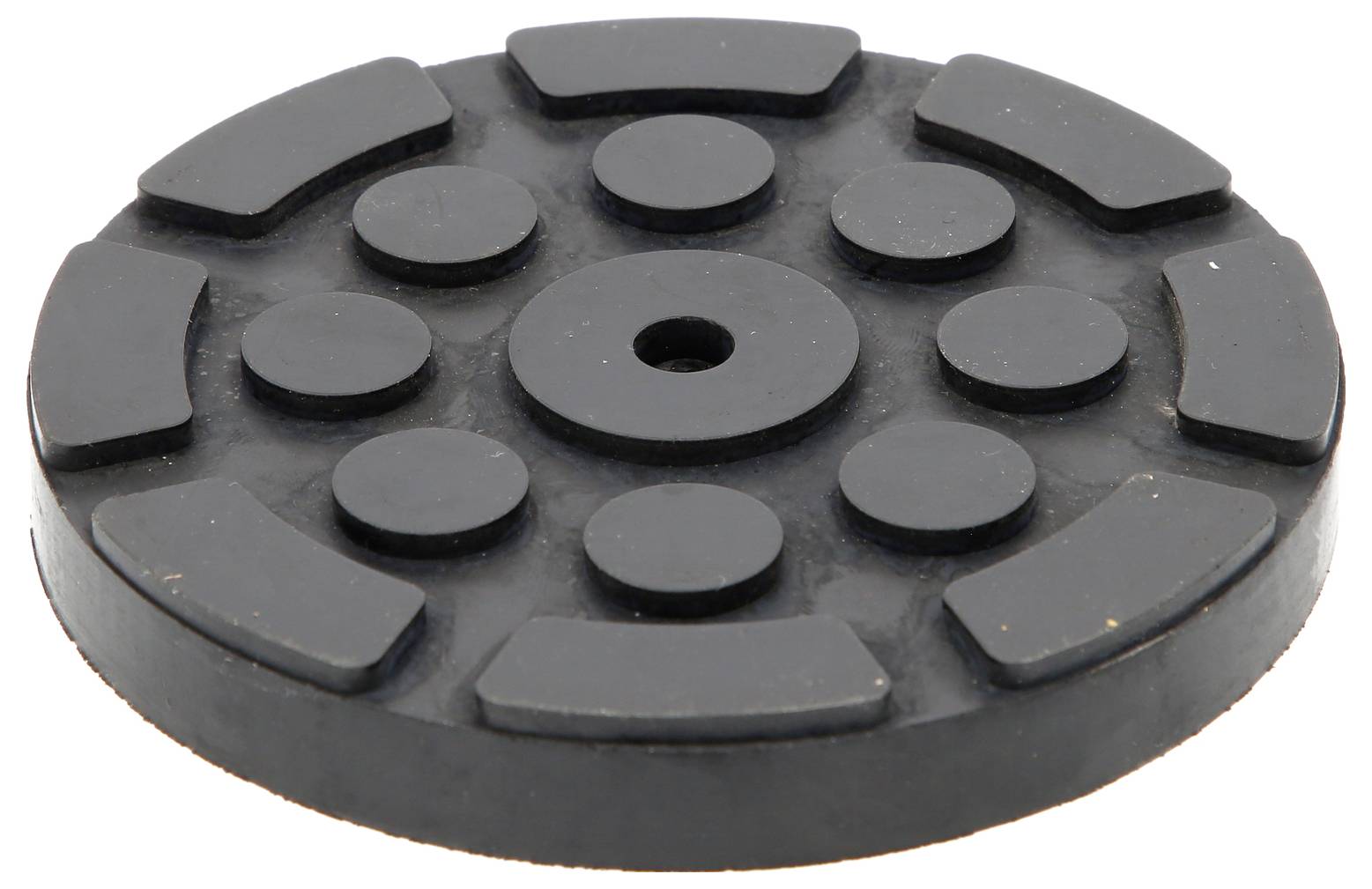Disque rond en caoutchouc noir avec des rayures et des cercles en relief disposés selon un motif symétrique.