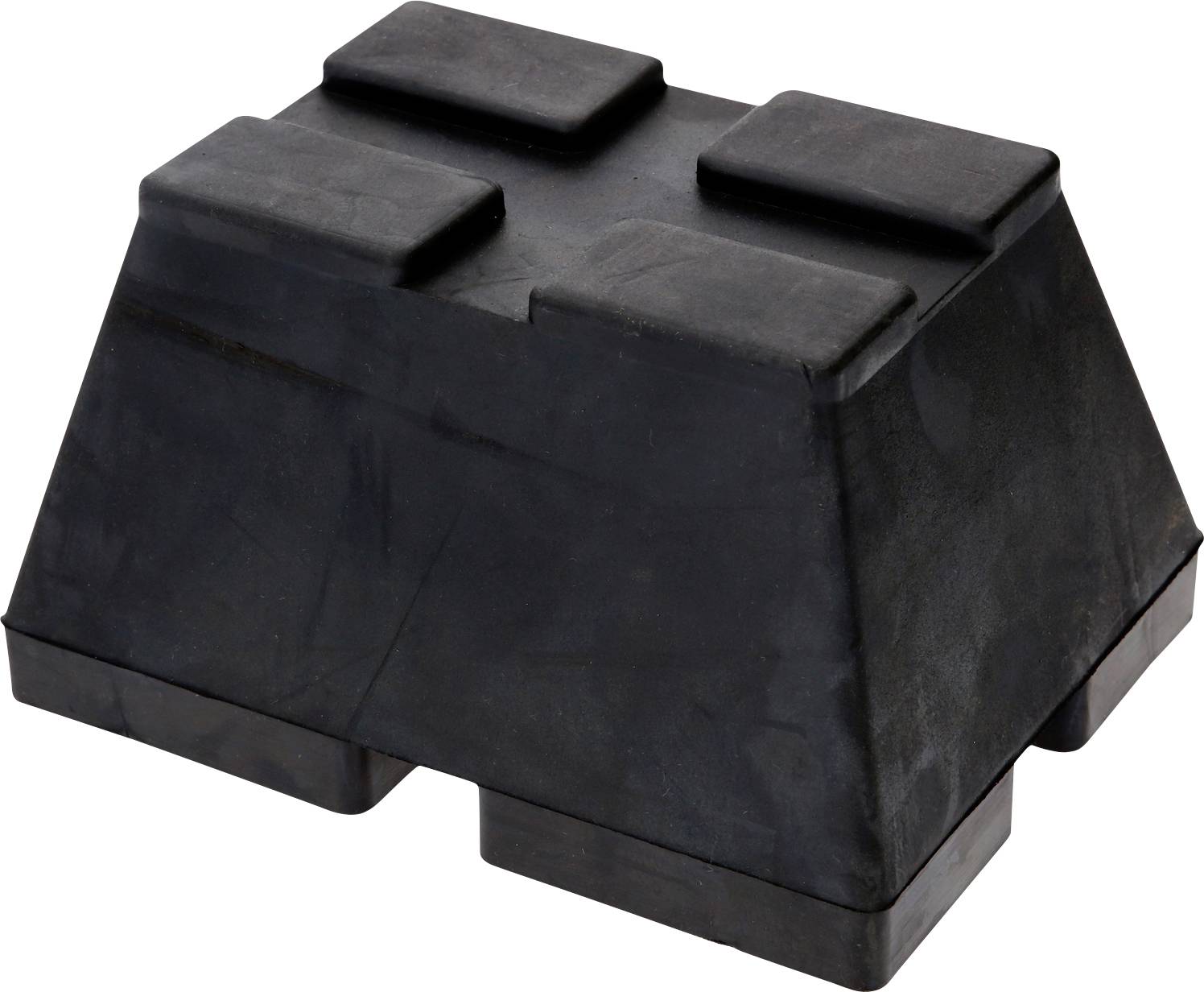 Un coin noir en caoutchouc avec quatre saillies rectangulaires sur le dessus et deux à la base. Matériau résistant à l'usure.
