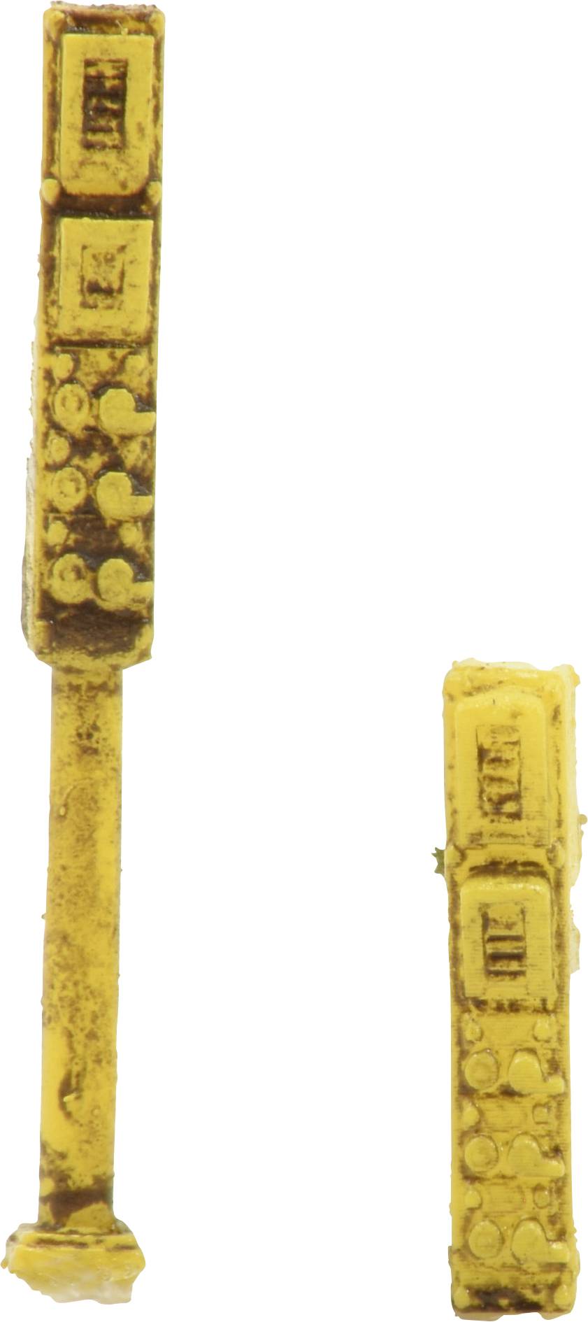 Deux composants électroniques jaunes et oblongs, de forme similaire à des résistances ou des condensateurs, sur un fond blanc.