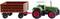 Tracteur jouet avec cabine verte et remorque rouge sur fond blanc.