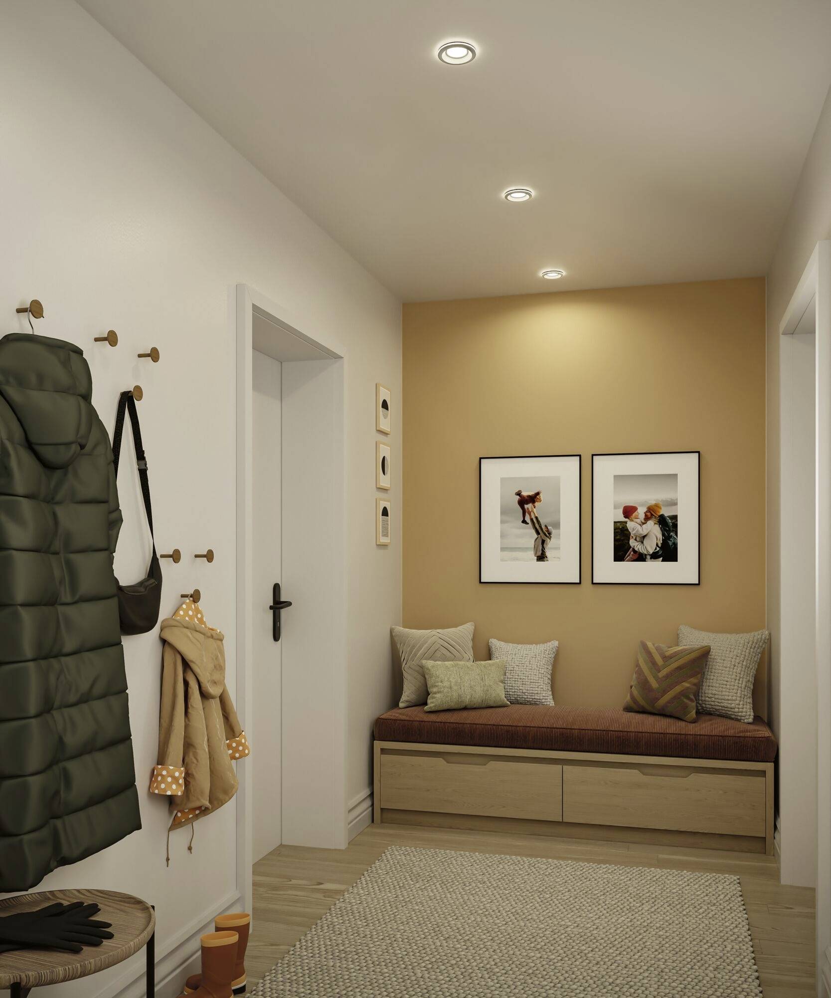 Entrée avec un banc, des luminaires suspendus et une décoration murale. À gauche, une veste et un sac sont accrochés. À droite, deux photos encadrées sont fixées au mur.