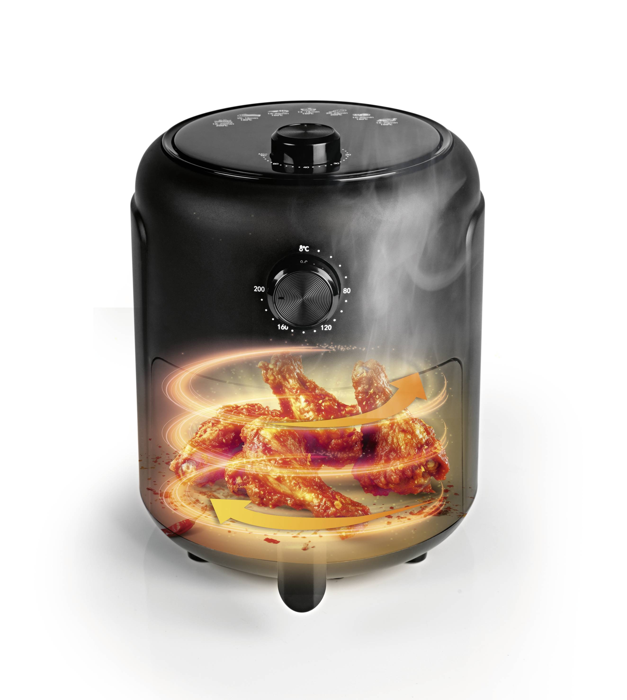 Une friteuse à air noir qui prépare des ailes de poulet avec des flux d'air rotatifs. De la vapeur s'échappe au-dessus.