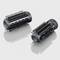 Deux brosses rondes noires à poils, se reflétant sur une surface grise. Adaptées pour les appareils de coiffure.