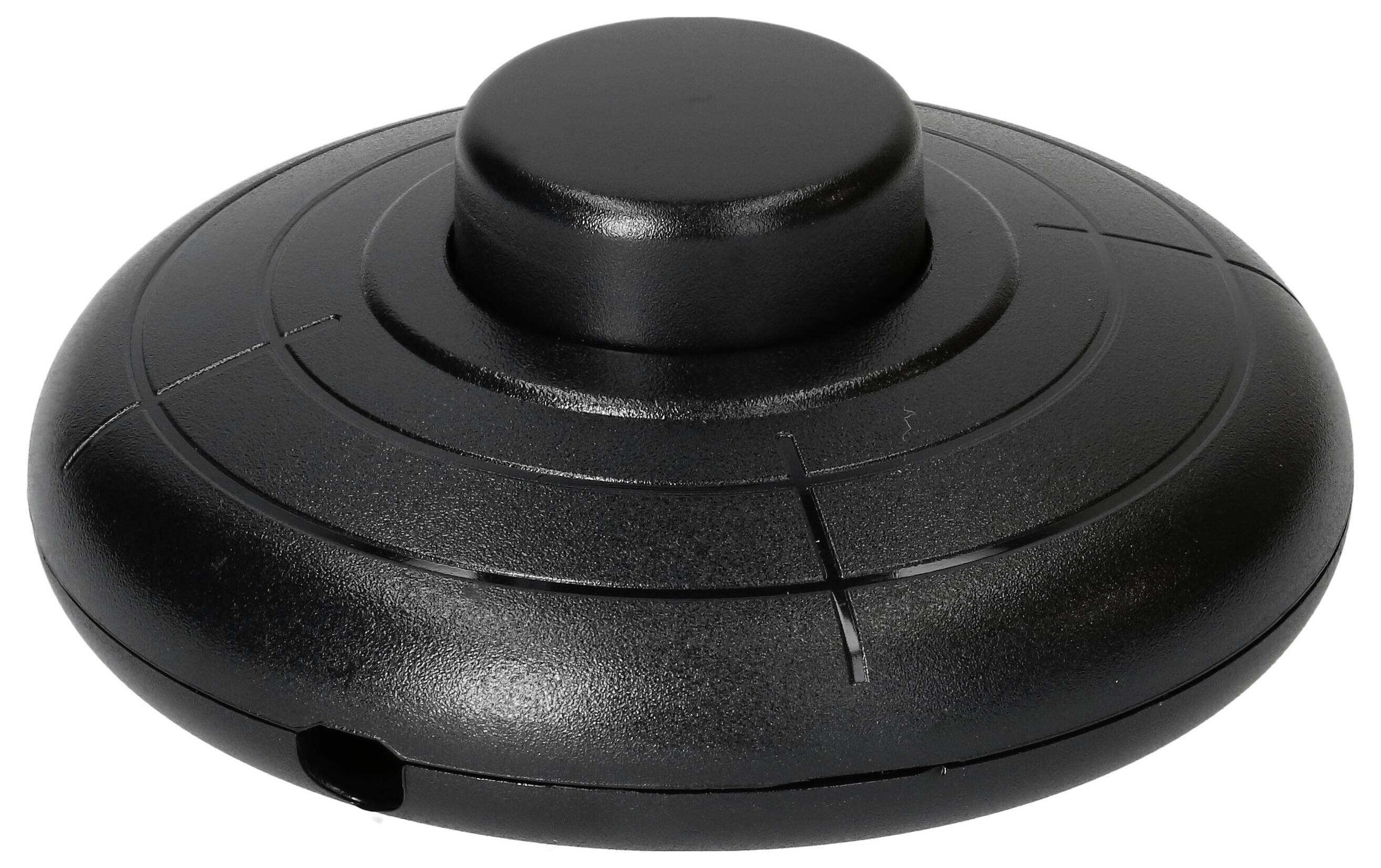 Un appareil électronique noir en forme de soucoupe volante, avec un bouton central surélevé.