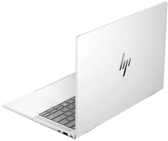 Ordinateur portable argenté avec un clavier noir, vu de côté ; fermé, avec le logo visible sur le couvercle.
