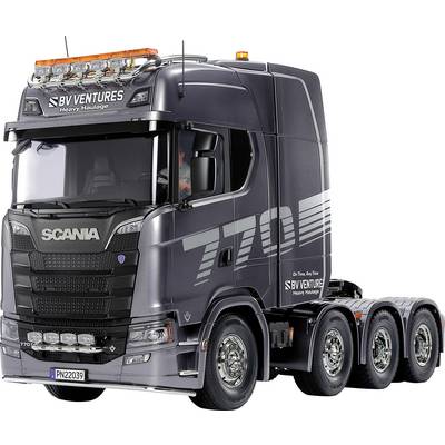 Un grand camion Scania noir avec les inscriptions '770' et 'BV Ventures' sur la cabine. Le camion possède plusieurs essieux.