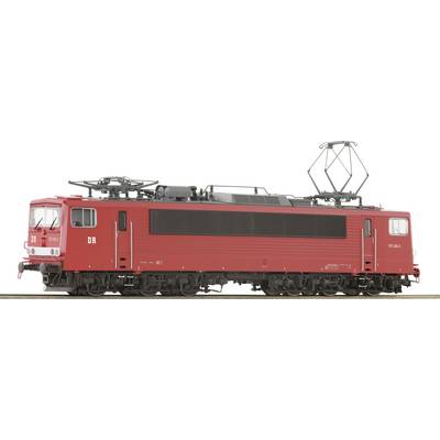 Une locomotive électrique rouge de la Deutsche Reichsbahn portant l'inscription 'DR' est positionnée sur le côté. Elle présente un design rectangulaire.