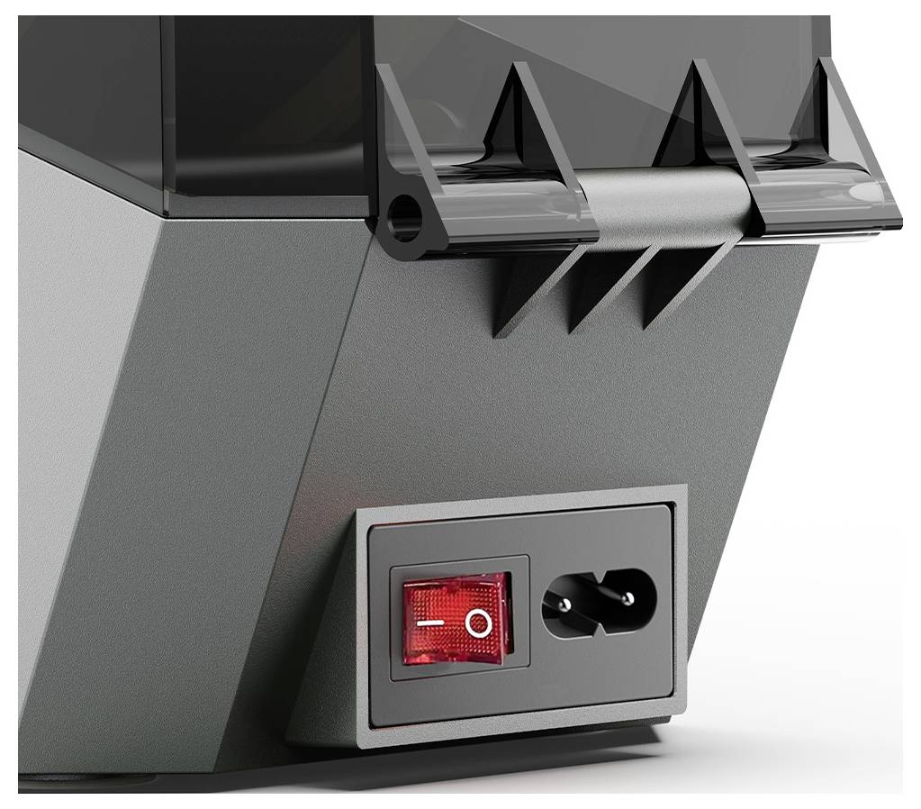 Vue en angle d'un appareil électrique gris avec un interrupteur à bascule rouge et une prise pour un câble d'alimentation.