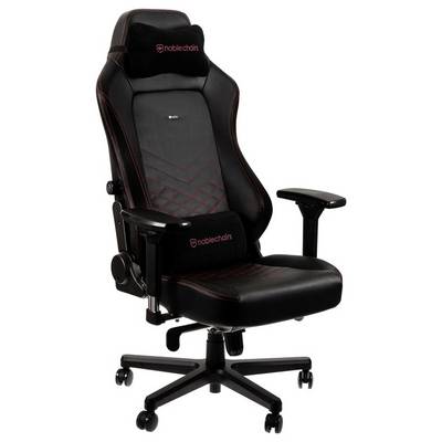 Chaise de gaming noire avec accoudoirs réglables, coutures rouges et appui-tête. Adaptée pour de longues périodes d'assise.