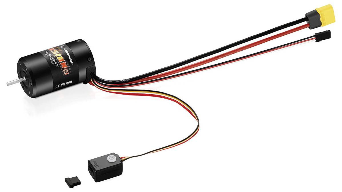 Un moteur électrique avec des câbles et des fiches est représenté. Un petit interrupteur est suspendu à un câble fin.