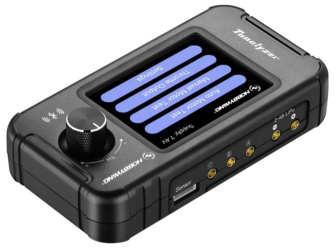 Un appareil électronique avec un écran et plusieurs boutons, probablement un contrôleur ou un testeur, doté d'un bouton rotatif distinctif sur la gauche.