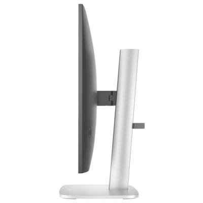 Vue latérale d'un moniteur d'ordinateur moderne avec un socle fin et argenté. L'écran est noir et fin.