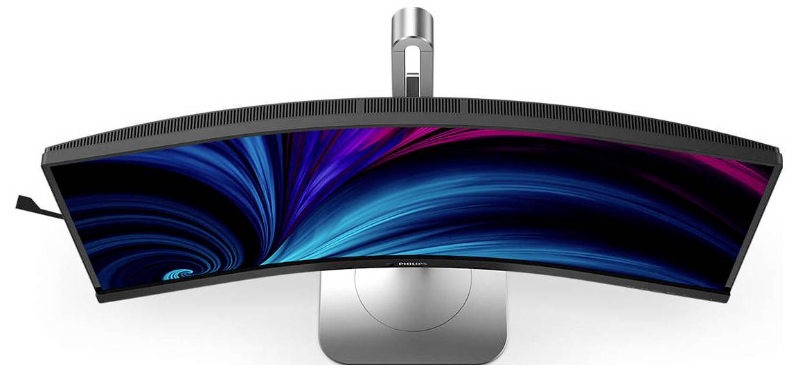 Un moniteur incurvé vu de dessus, avec un écran abstrait et coloré en tons de bleu et de rose, posé sur un socle argenté.