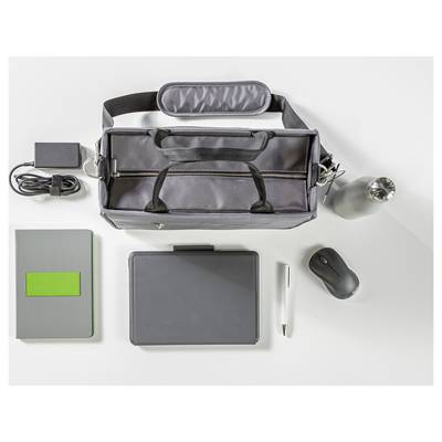 Une vue de dessus d'un sac noir avec un chargeur, une bouteille d'eau, une souris, un carnet, une tablette et un stylo disposés soigneusement sur une surface gris clair.
